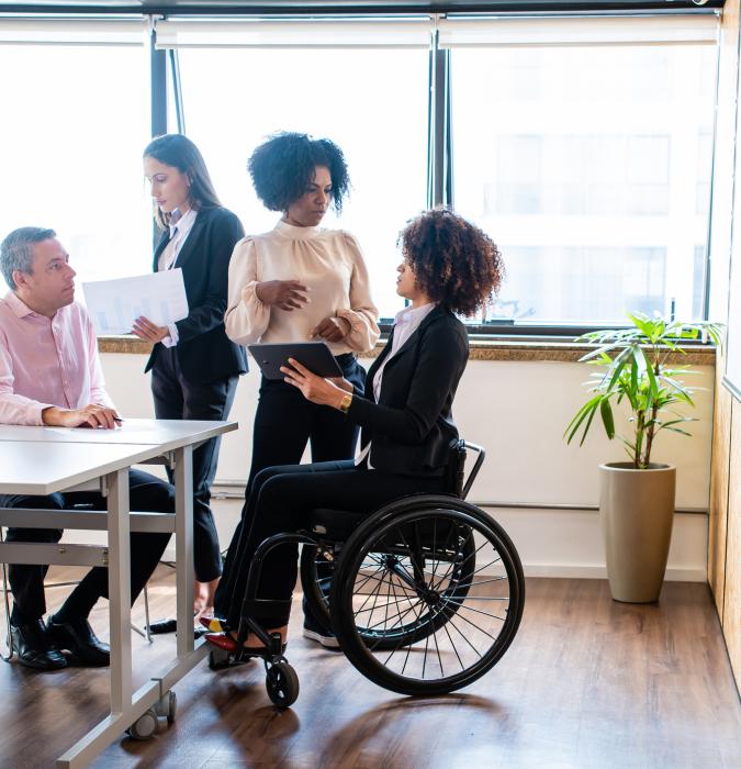 Group of diverse business professionals, woman in wheelchair, equity and inclusion